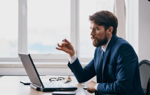 man talking to it company remotely on computer